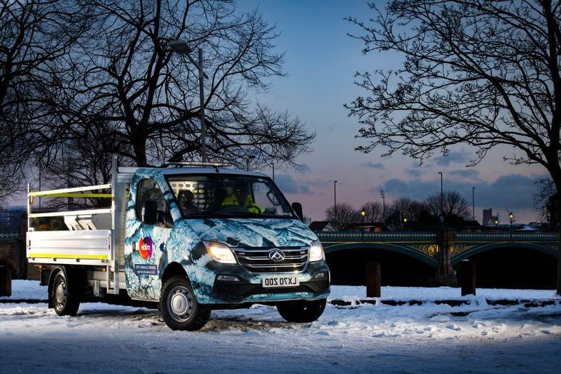 Mitie van, with a snowflake branding, on a road covered in snow